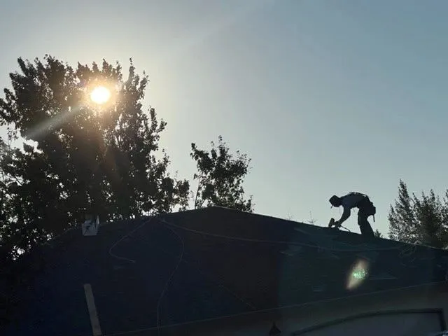 Roofing crew installing architectural asphalt shingles on a Clark County, WA home
