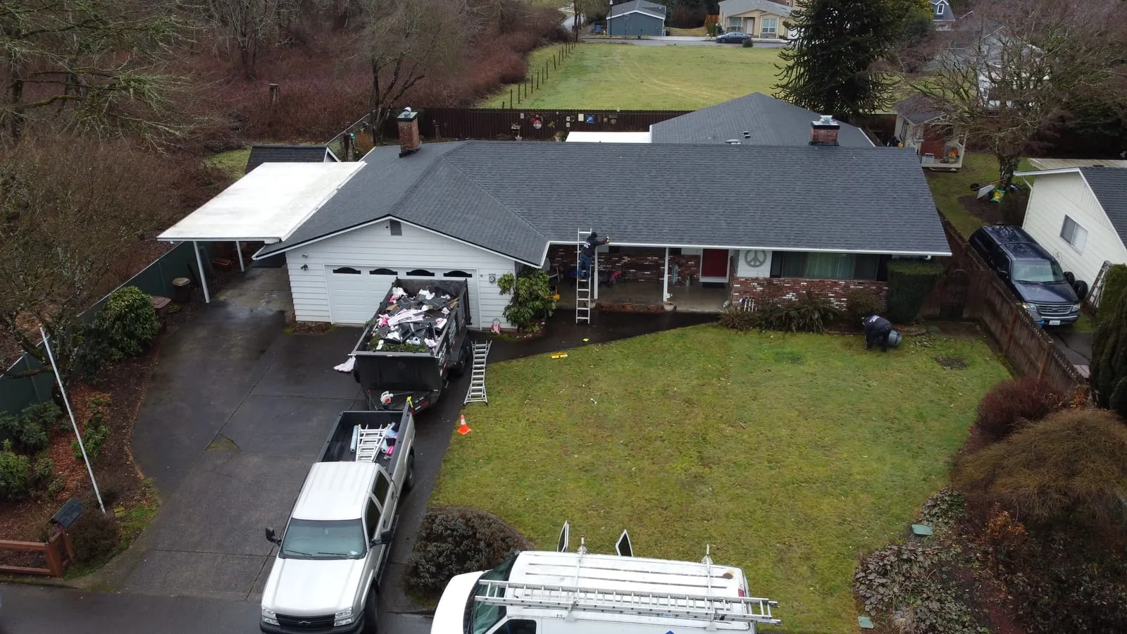 Drone aerial of the Camas, WA roof replacement - multi-gable hillside home with new architectural shingles, view 1