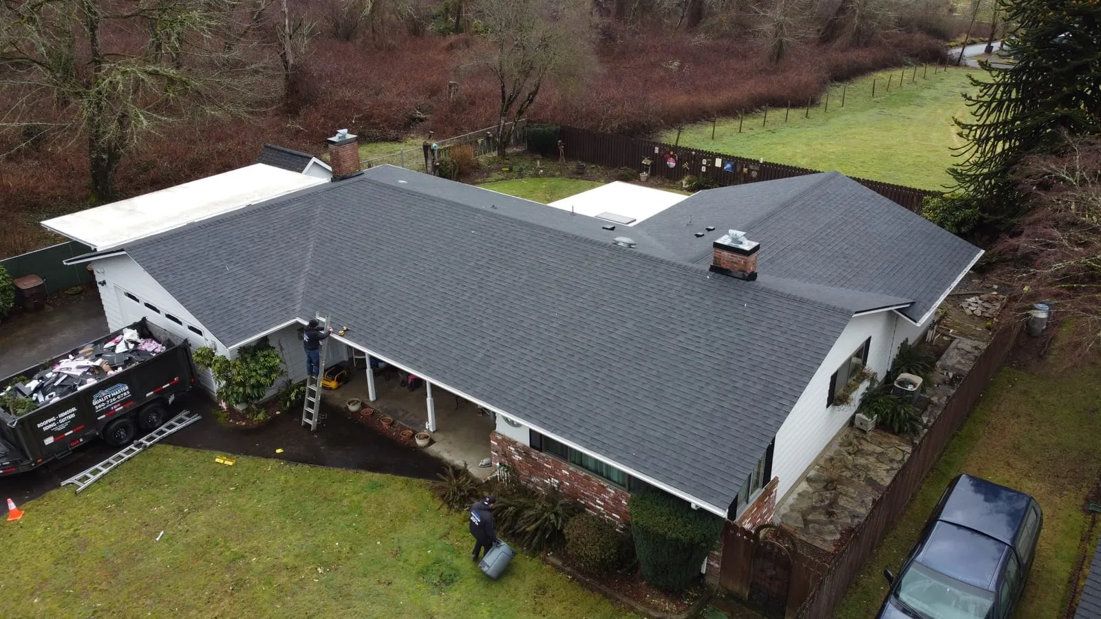 Drone aerial of the Camas, WA roof replacement - multi-gable hillside home with new architectural shingles, view 2