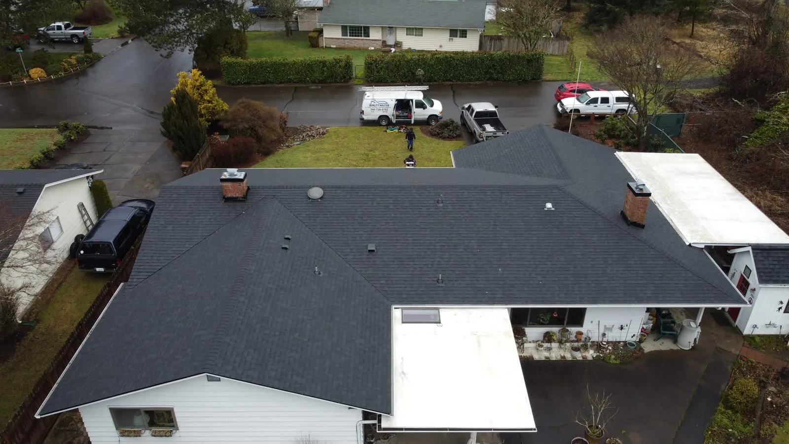Drone aerial of the Camas, WA roof replacement - multi-gable hillside home with new architectural shingles, view 3